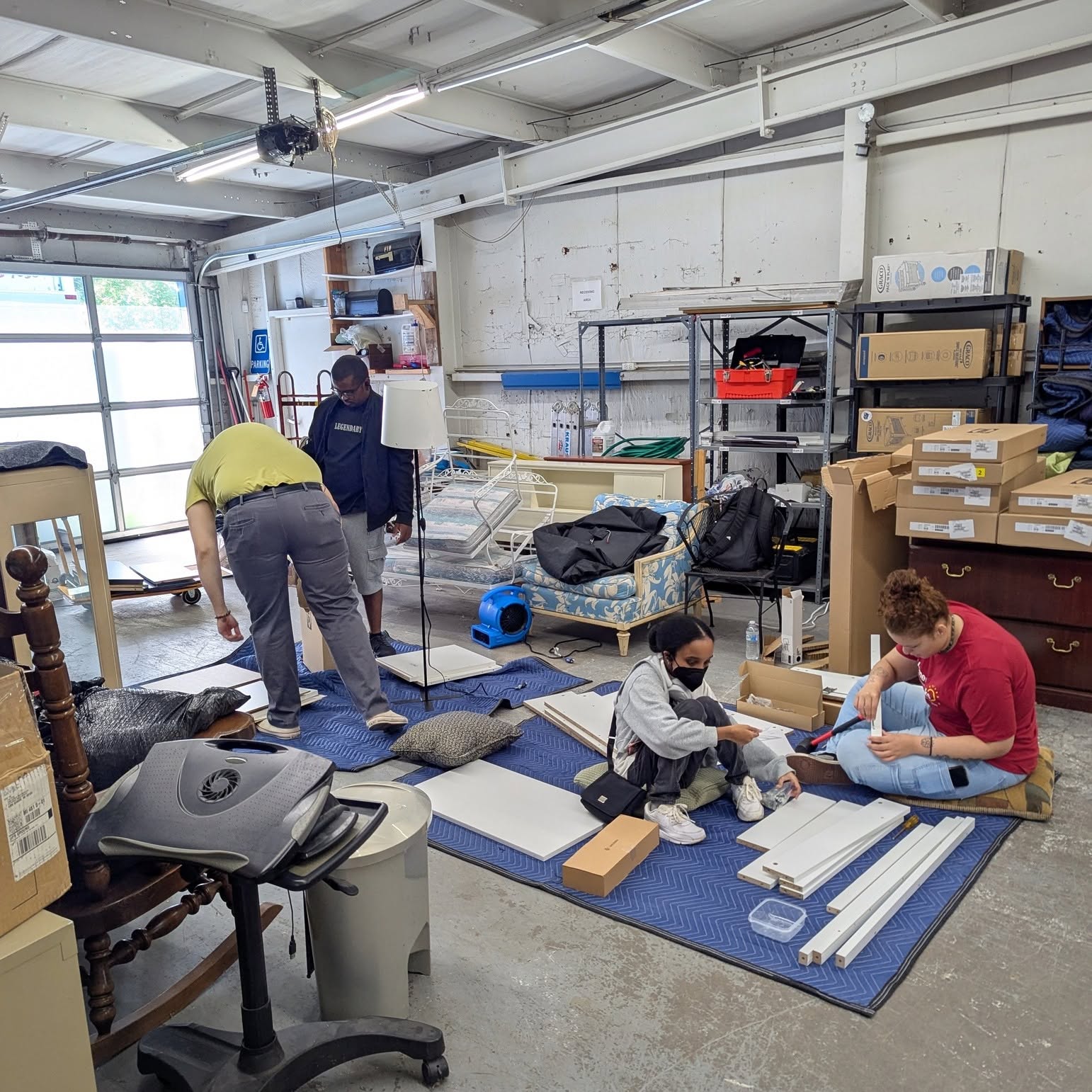 Volunteers assembling furniture in the warehouse